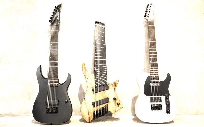 Extended range electric guitars including a 7-string, 8-string multiscale with fanned frets, and a baritone guitar showing longer scale lengths and extra strings