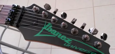 7-string and 8-string electric guitars side by side showing extended-range fretboards