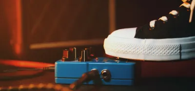Guitar compressor pedal positioned at the front of a pedalboard signal chain