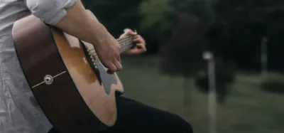 Solid-top acoustic guitar resting in natural light as the wood ages and opens up