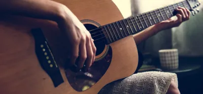 Acoustic guitar top with a pickguard mounted below the soundhole