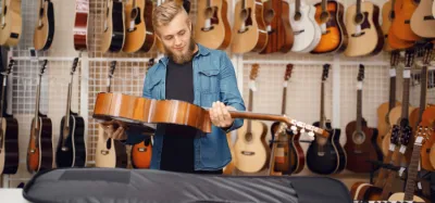 Lineup of acoustic guitars in different body sizes from parlor to jumbo