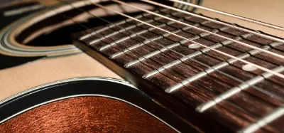 Close-up of acoustic guitar strings showing wound metal coils
