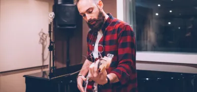 Beginner guitarist practicing a rock song on an electric guitar