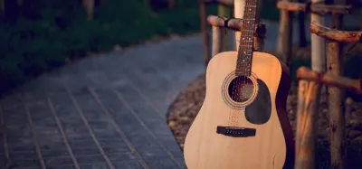 Several acoustic guitars lined up in a guitar shop ready to test
