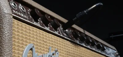 Tube guitar combo amp paired with a distortion pedal on a pedalboard