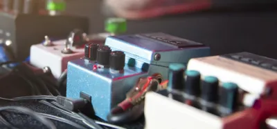 Analog delay pedals lined up on a pedalboard with warm vintage tone