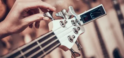 Clip-on tuner attached to an acoustic guitar headstock