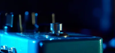 Digital delay pedals lined up on a guitar pedalboard