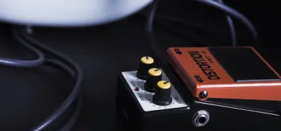 Guitar distortion pedals lined up on a pedalboard