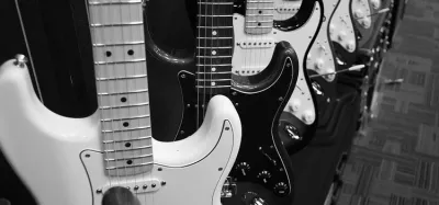 Lineup of electric guitars under $300 against a studio backdrop