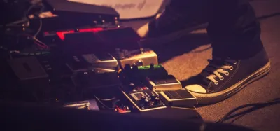 Fuzz pedals lined up on a pedalboard for stoner rock and doom guitar tone