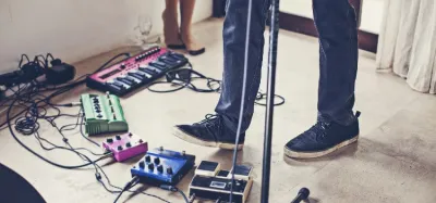 Looper pedal on a guitarist's pedalboard during a live performance