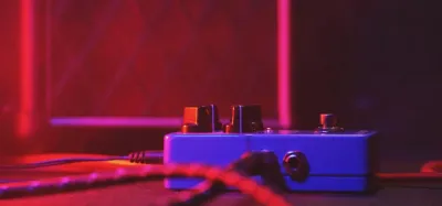 Several budget guitar looper pedals under 100 dollars on a pedalboard