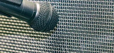 Dynamic microphone close-miking a guitar amp speaker cabinet