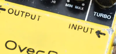 A row of overdrive guitar pedals on a pedalboard