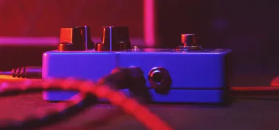 Stereo delay pedals on a pedalboard with two output cables connected