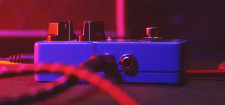 Stereo delay pedals on a pedalboard with two output cables connected