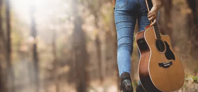 Compact travel acoustic guitar ready to pack for a trip