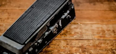 A row of guitar wah pedals lined up on a pedalboard