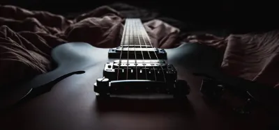 Close-up of a semi-hollow body guitar showing its figured wood top and f-hole