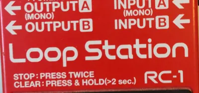 A Boss Loop Station guitar pedal on a pedalboard