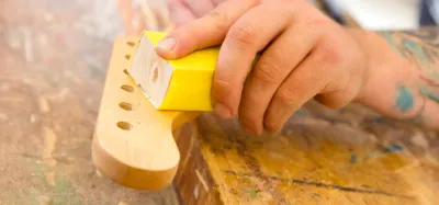 Close-up of an electric guitar body showing the natural wood grain