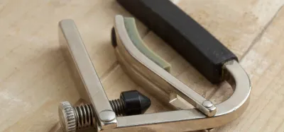 Capo clamped on the neck of an electric guitar
