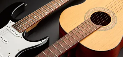 A guitar neck showing the fingerboard, frets, and headstock