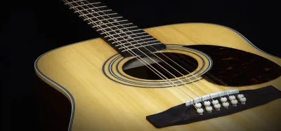 Grand auditorium and dreadnought acoustic guitar body shapes side by side