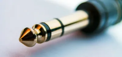 Close-up of a 1/4 inch input jack on a guitar amplifier with a cable plugged in