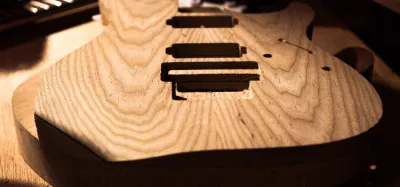 Hardboard and MDF guitar body templates traced and cut to shape on a workbench