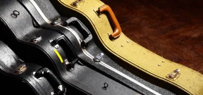 Replacement carry handle attached to a hard guitar case