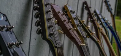Several guitar headstocks showing pointy, rounded, and square shapes with machine heads mounted