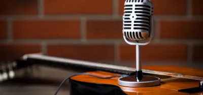Guitarist playing while a guitar radio station streams in the background