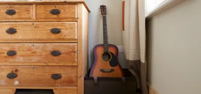 Acoustic guitar stored safely in a case to protect it from temperature and humidity changes