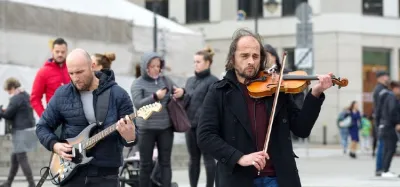 An acoustic guitar and a violin side by side for comparison
