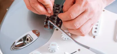 Close-up of an electric guitar bridge with a whammy bar installed
