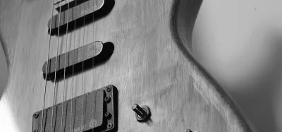 Close-up of electromagnetic pickups on an electric guitar body