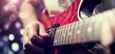 Close-up of a guitar fretboard showing the frets along the neck