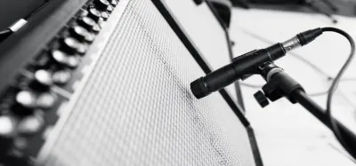 Dynamic microphone placed in front of a guitar amp speaker grille