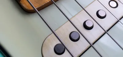 Close-up of single coil pickups on an electric guitar that produce hum