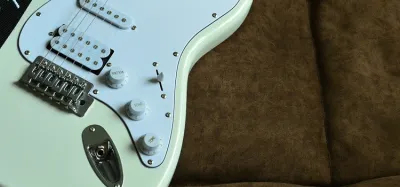 Volume and tone knobs and pickup selector on an electric guitar