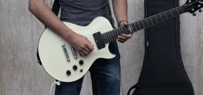 Ultimate Guitar Pro interactive tab player open on a laptop next to a guitar