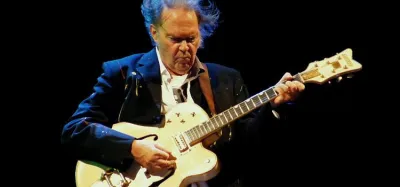 Acoustic guitar set up to learn beginner Neil Young songs