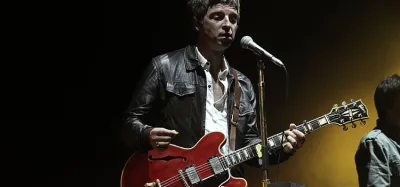 Beginner guitarist learning Noel Gallagher Oasis songs on acoustic guitar