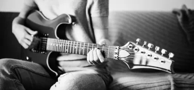 Guitarist playing a single-note riff on an electric guitar