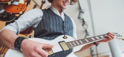 Beginner playing simple two-chord songs on an acoustic guitar