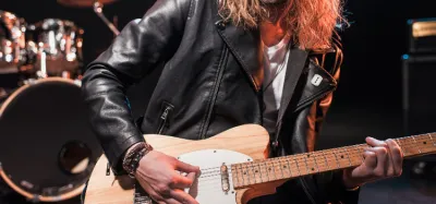 Guitarist playing heavy metal riffs on an electric guitar