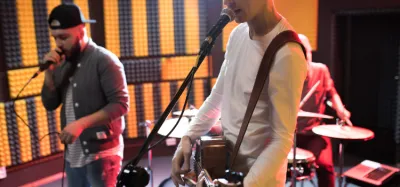 Guitarist playing along to hip-hop music for beginners